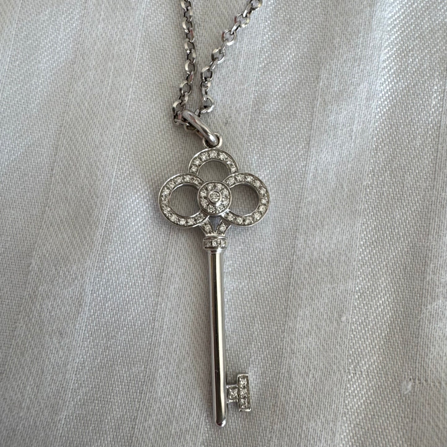 תליון מפתח אייקוני של Tiffany & Co. זהב לבן 18 קראט משובץ יהלומים עדינים.