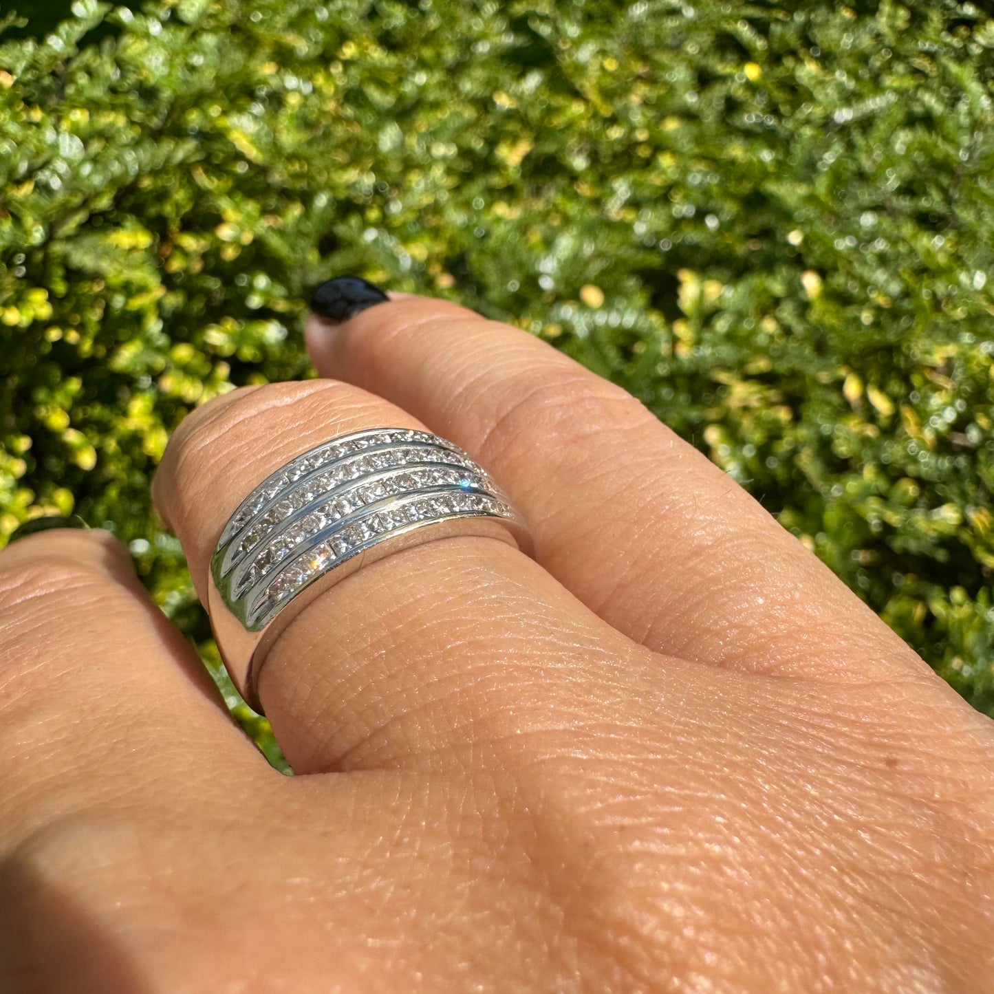 14K gold ring set with four parallel rows of princess-cut Diamonds.