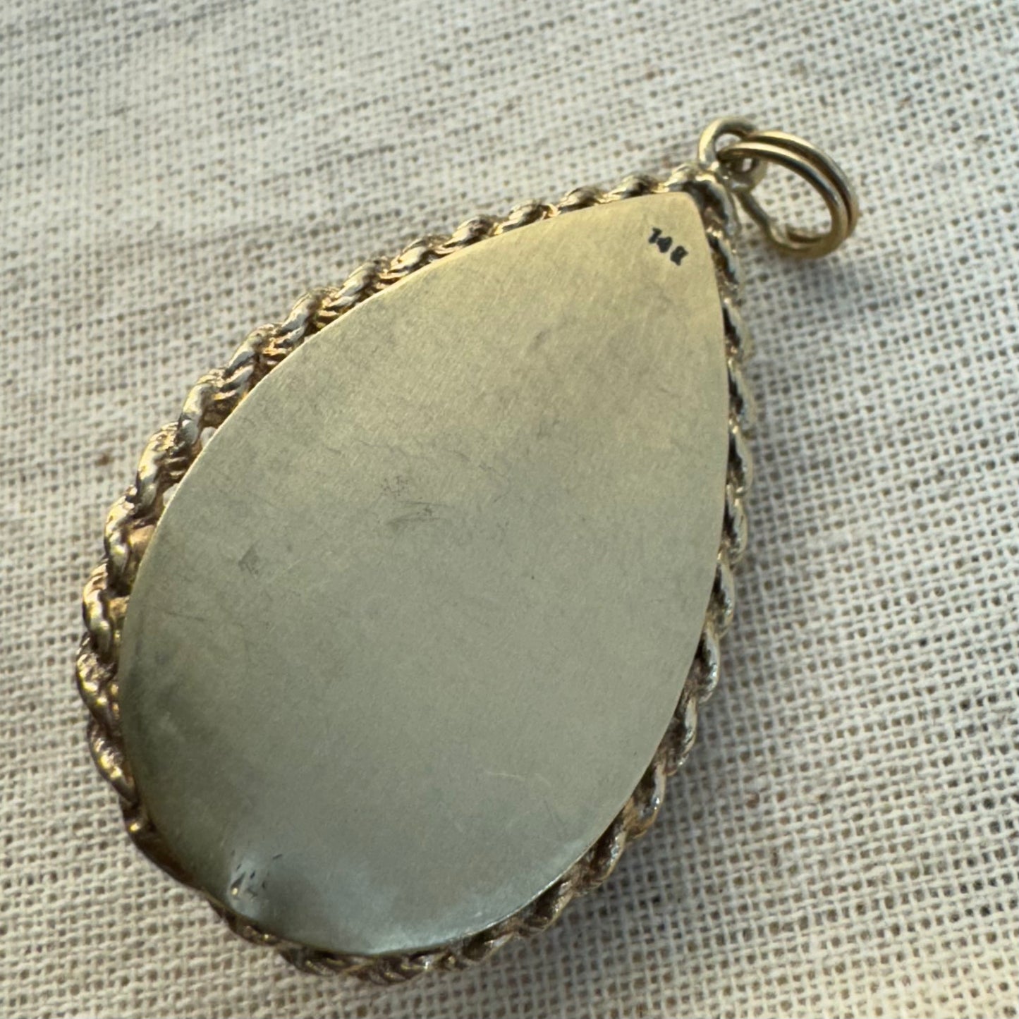 14K gold locket pendant set with an Amethyst gemstone