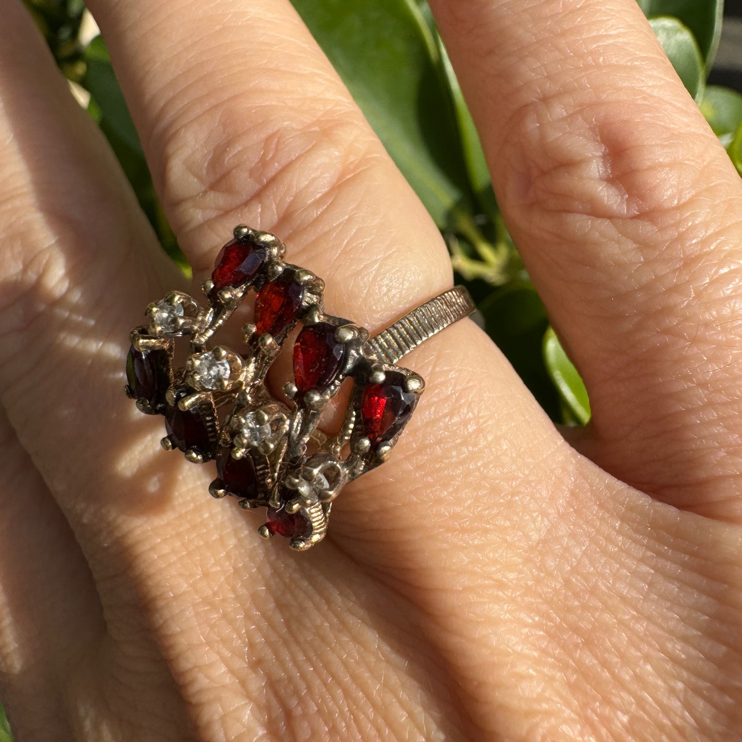 14K gold ring set with deep red teardrop Garnets and sparkling Diamonds in an openwork geometric design