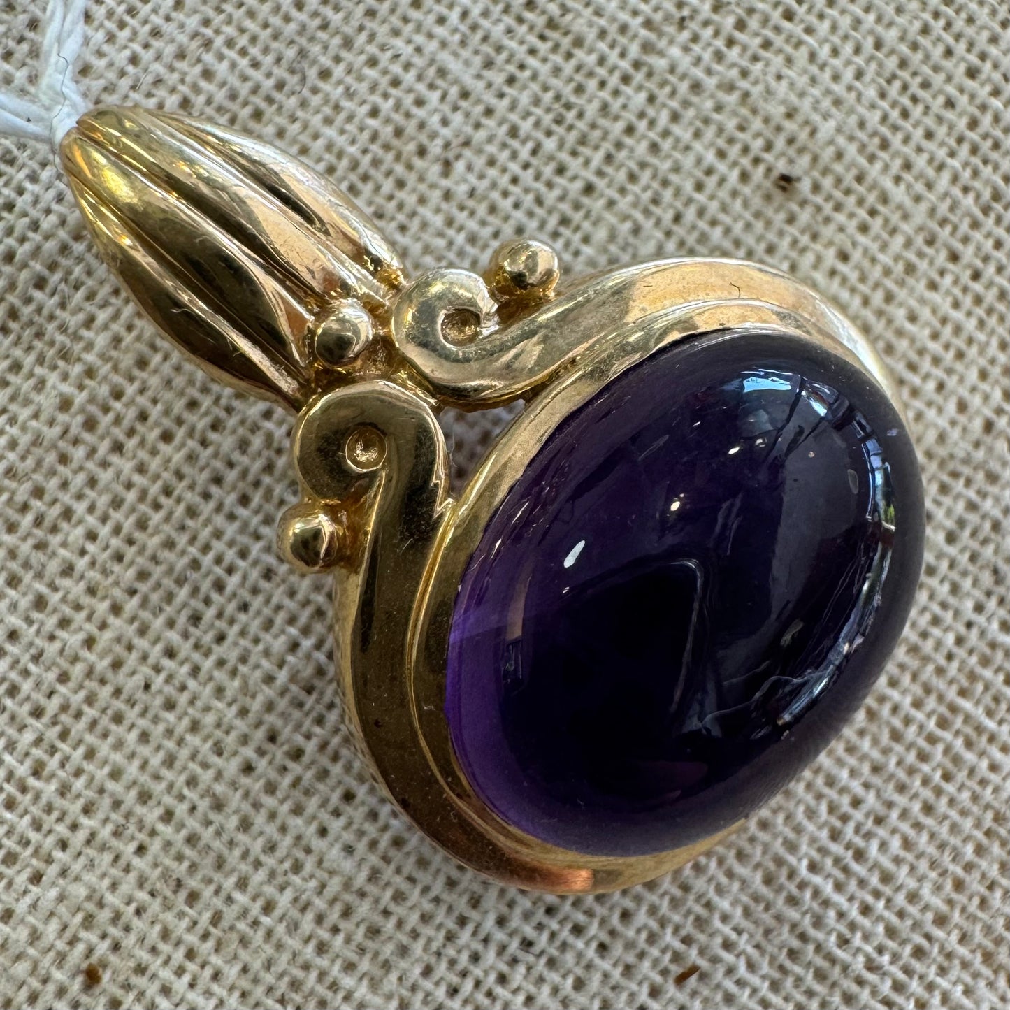 14K gold pendant set with a large cabochon Amethyst