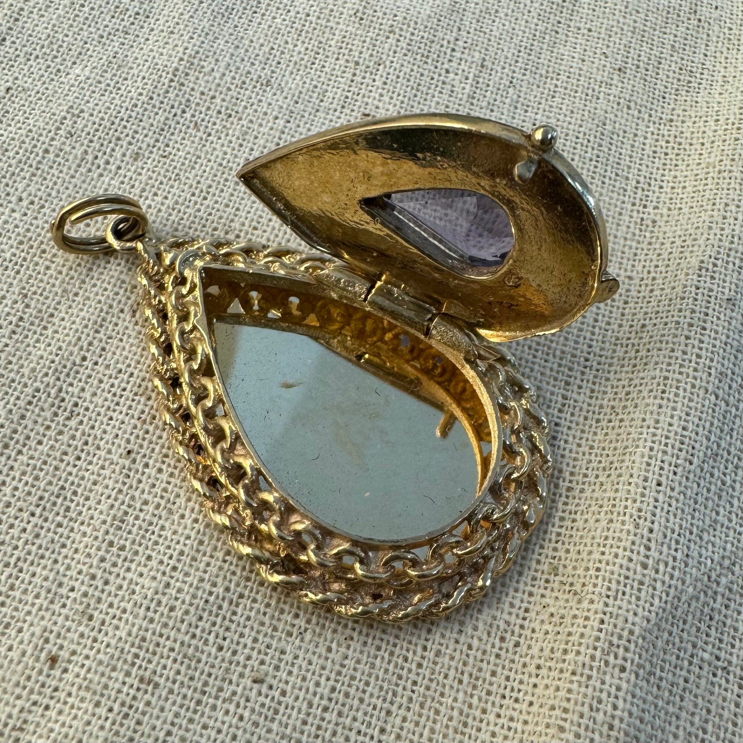 14K gold locket pendant set with an Amethyst gemstone