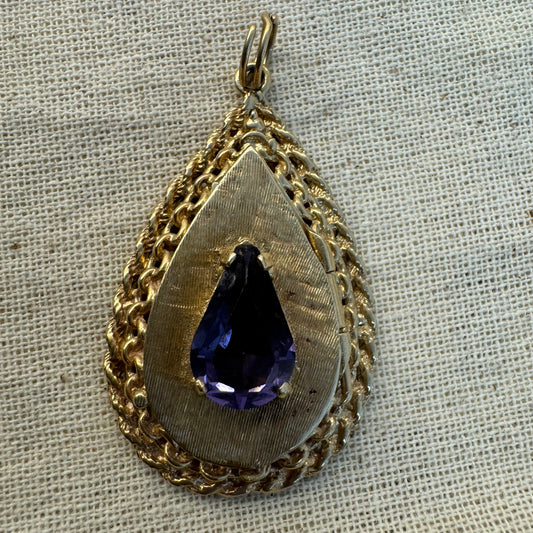 14K gold locket pendant set with an Amethyst gemstone