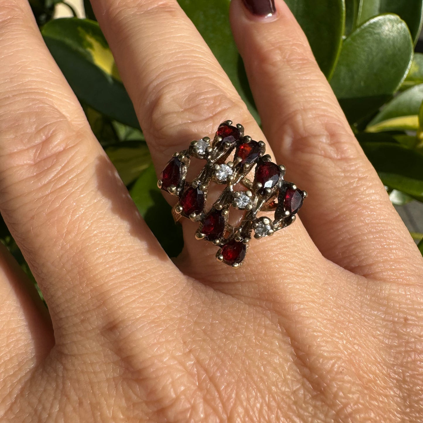 14K gold ring set with deep red teardrop Garnets and sparkling Diamonds in an openwork geometric design