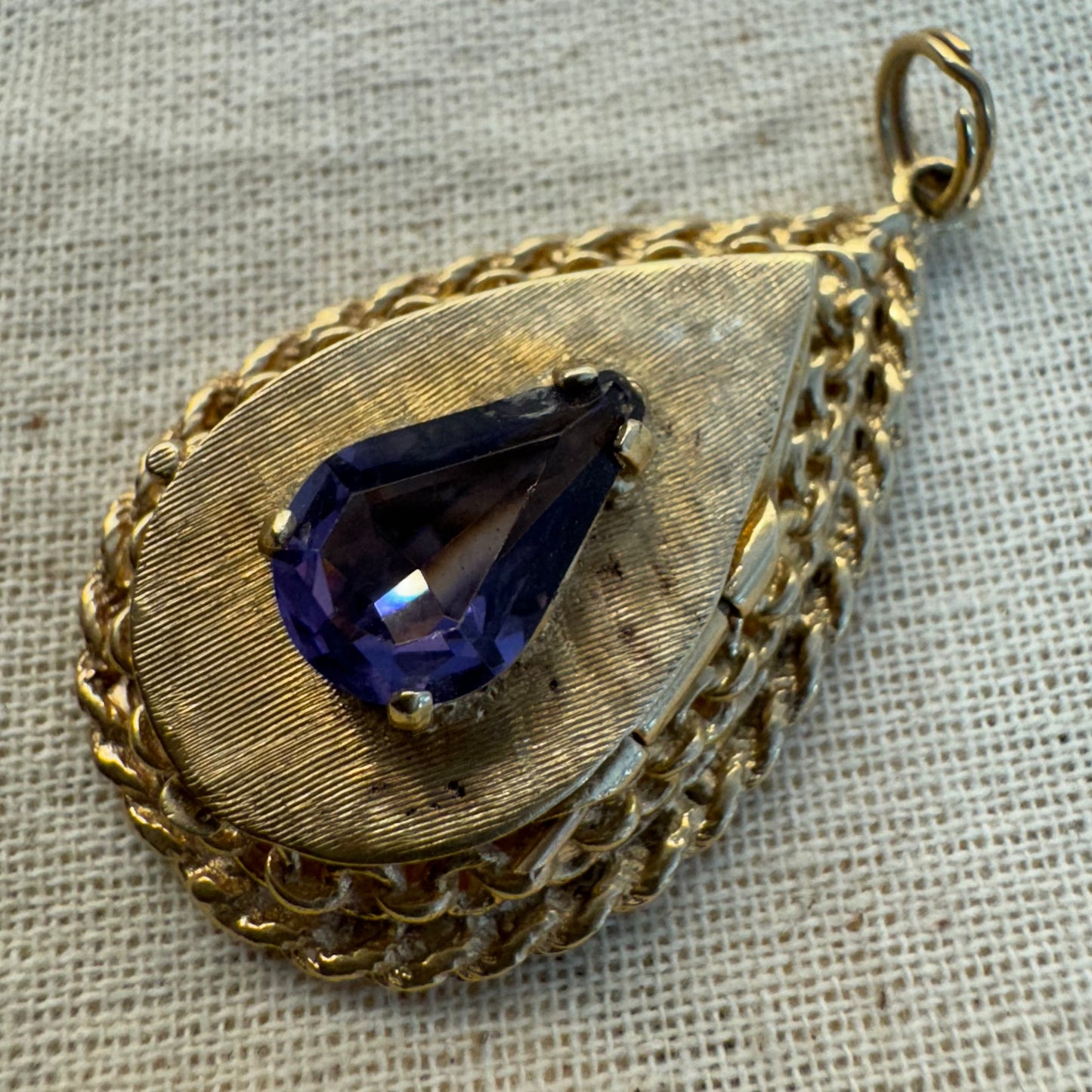 14K gold locket pendant set with an Amethyst gemstone