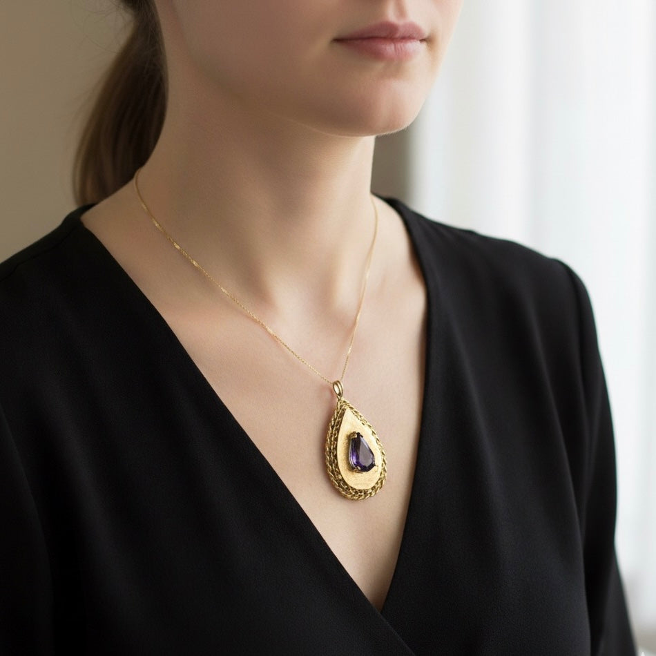 14K gold locket pendant set with an Amethyst gemstone