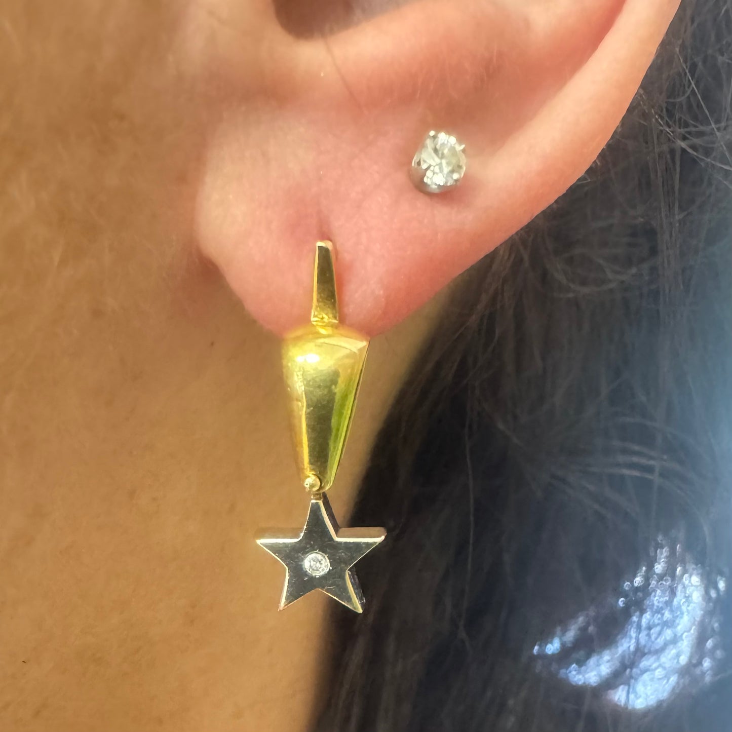 18K gold earrings set with a sparkling Diamond at the center.