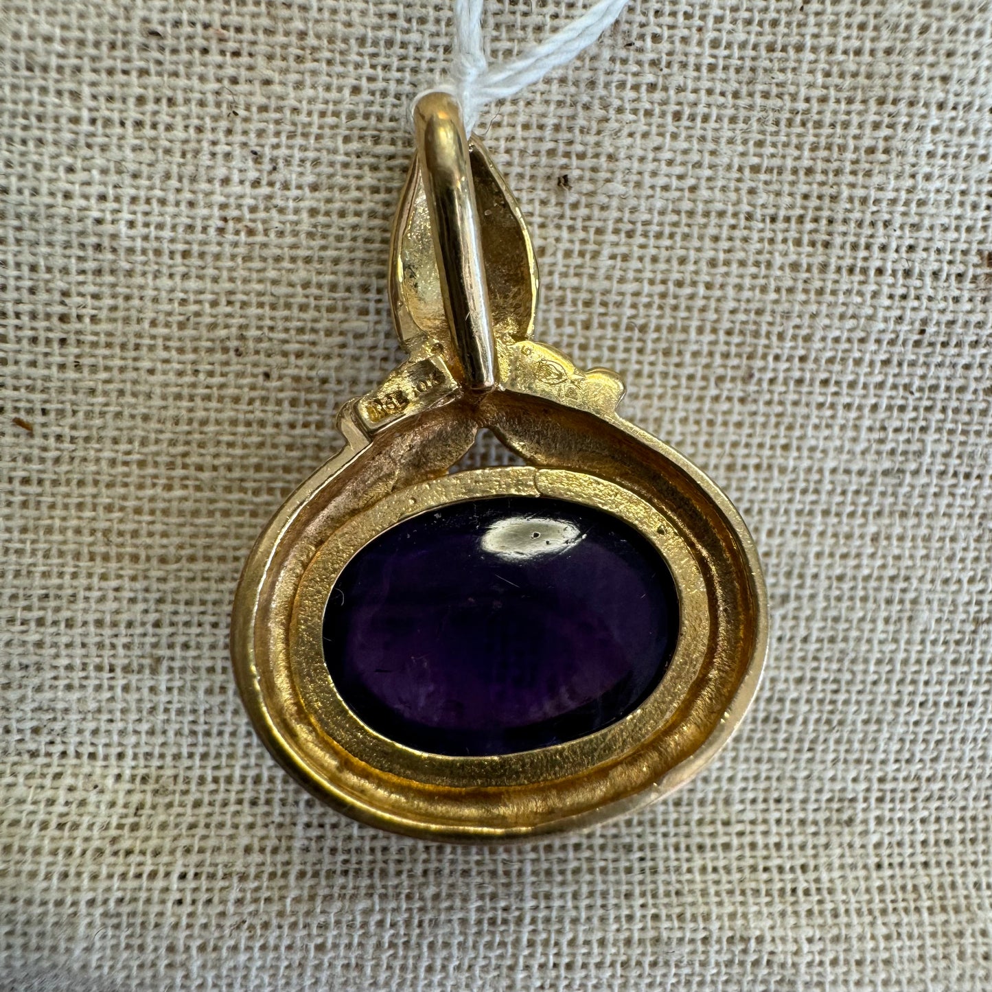 14K gold pendant set with a large cabochon Amethyst